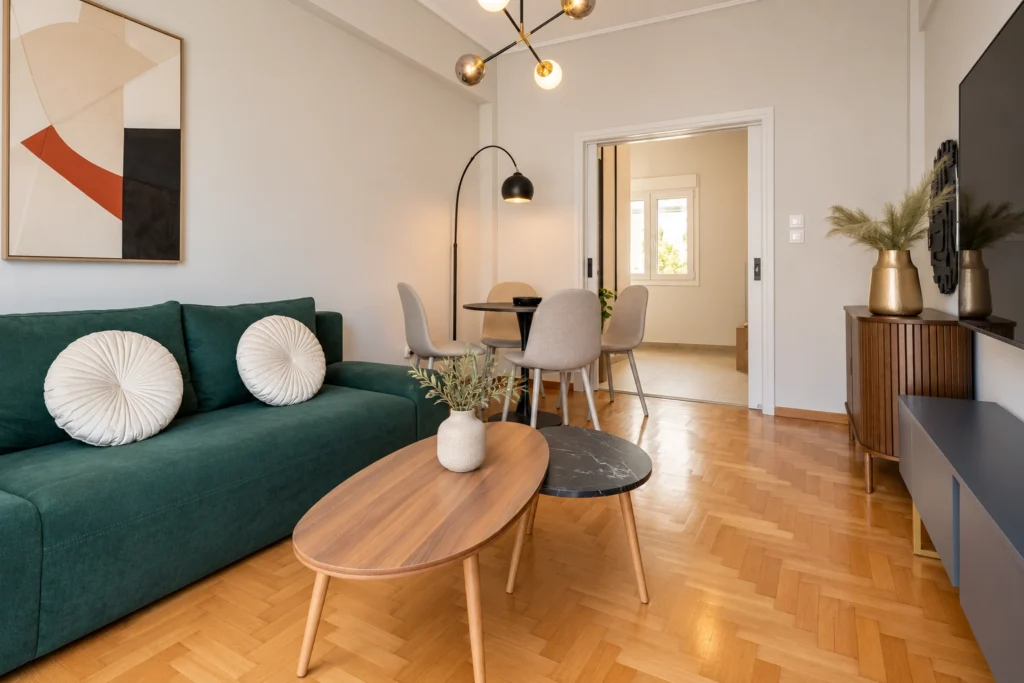 Green sofa and oval coffee table in the living room, Timeless Kallisto, Koukaki – IDYLI Architects